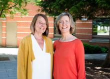 Adrienne and Heidi standing together and smiling.